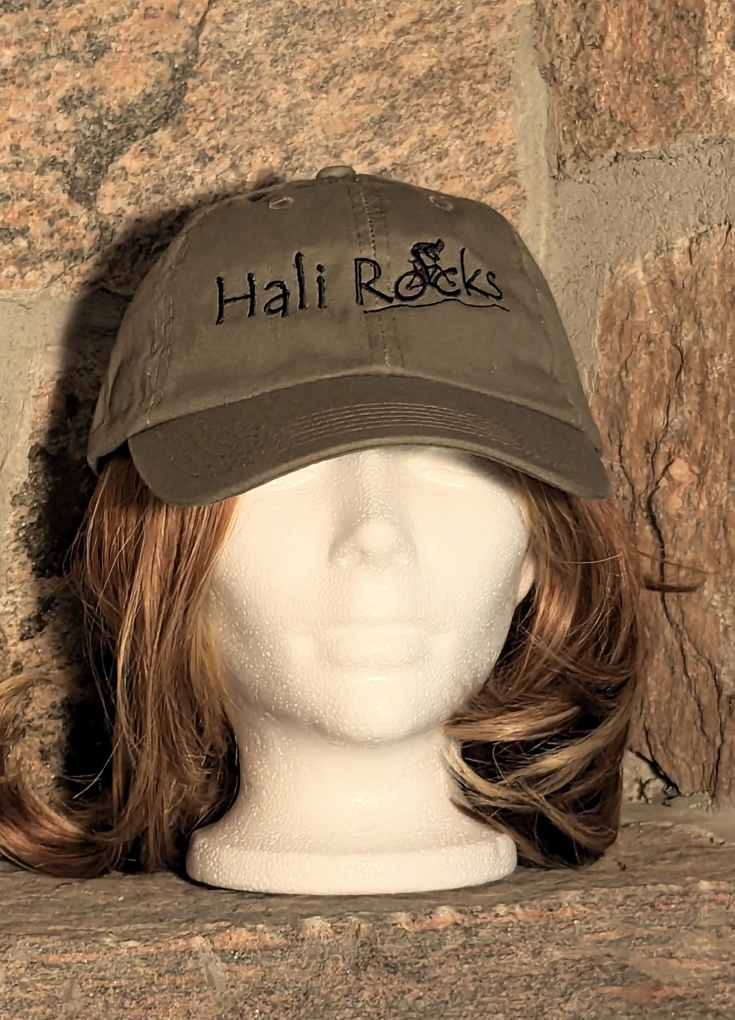 Hali Rocks Mtb Hat 100% Cotton regular curved peak colour = olive green Embroidery = Black with cyclist climbing rocky trail