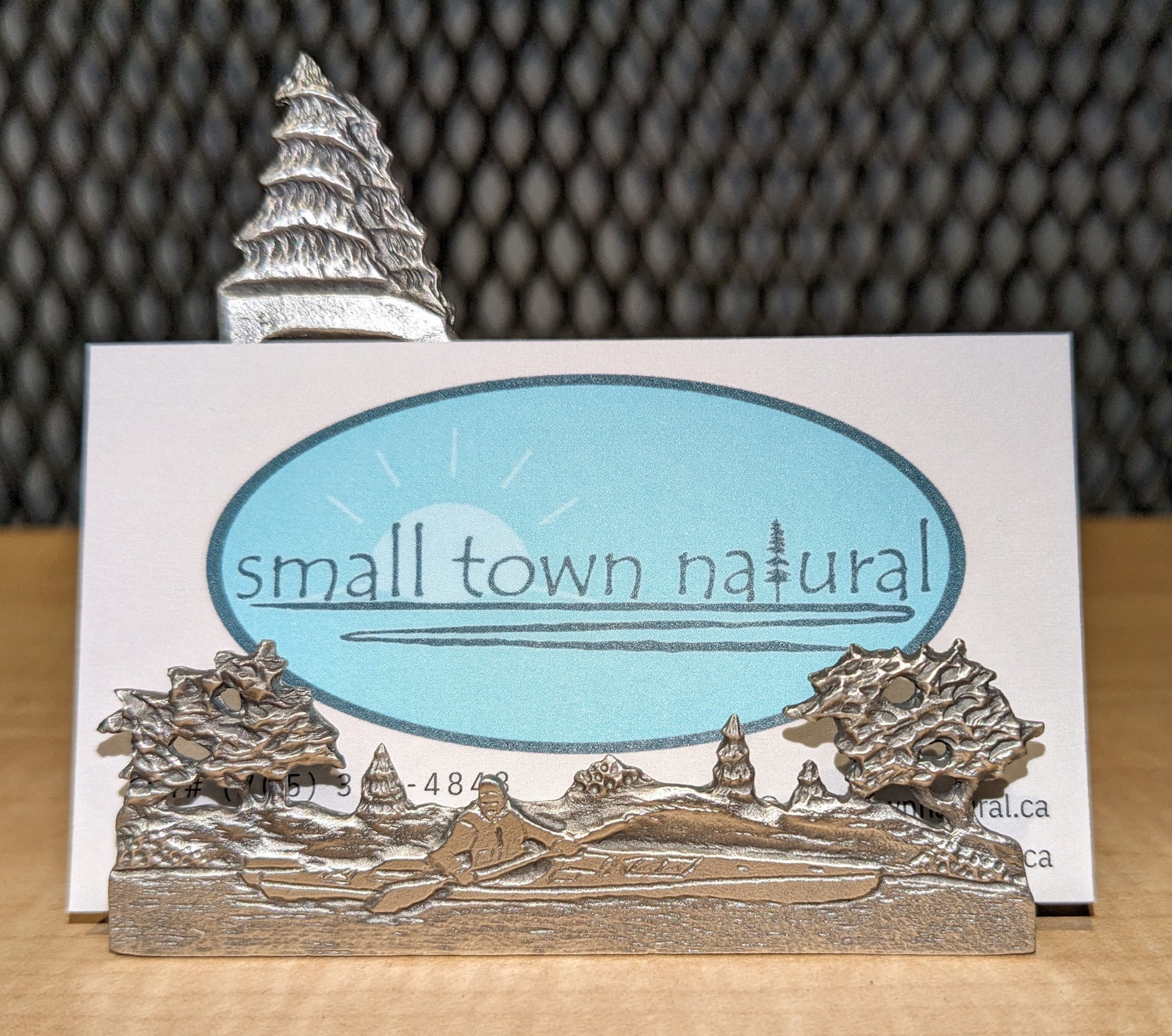 Small Town Natural now carries this outdoorsy business card holder that depicts a scene of a canoer paddling in the wilderness with a couple spruce trees in the background + other trees and shrubs in foreground. Great for any outdoor adventuring biz or the outdoor enthusiast's work or office desk. All pewter. Handmade in Ontario Canada since 1972