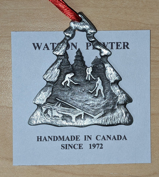 Pewter Ornament with scene including trees, bench and a group of pond hockey players