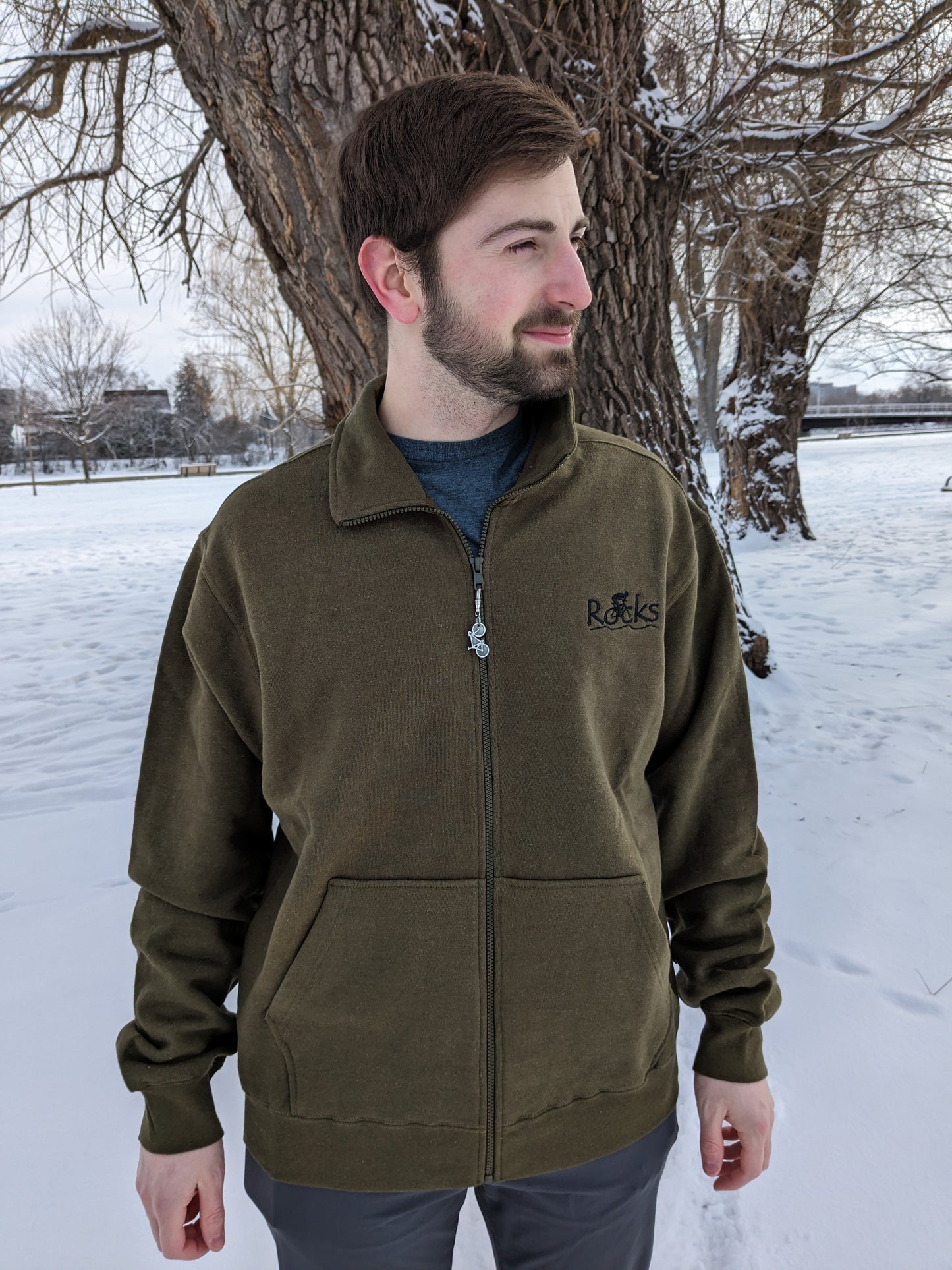 Small Town Natural male model Jonas is wearing an XL sized olive coloured 'Rocks' with cyclist Hemp Track Jacket. This model typically wears a Medium. The XL is to show how a larger size provides that roomy baggy look